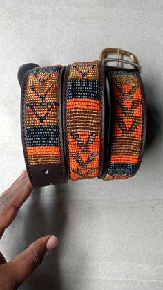 Masai belt, Leather belt, Beaded belt, Handmade belt, Maasai beaded leather belt, African beaded belt, Men belt, Casual belt, Boho belt, The Belts are made from ethically sourced leather in Kenya. The belts are then hand beaded by Maasai women artisans from the Village who have mastered the art. The Buckle and ring are made from 100% recycled brass. TO MEASURE CORRECTLY Our measurements are from the tip of the Buckle of the Collar to the second hole after the beaded section. GENERAL BELT SIZE Boho Belts, Handmade Belts, Beaded Belt, Casual Belt, Maasai, Women Artisans, Suspender Belt, Bead Leather, Belt Size