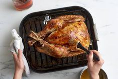 a person is cutting up a turkey on a grill with the best list sticker above it