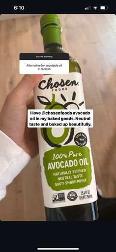 someone is holding up a bottle of avocado oil with an ad on it