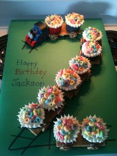 a birthday card with cupcakes shaped like a train