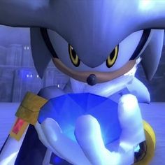 sonic the hedgehog is holding a blue object