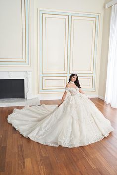 a woman in a wedding dress is posing for the camera