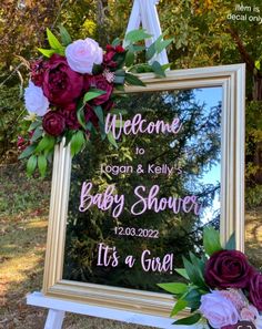 a baby shower sign with flowers on it