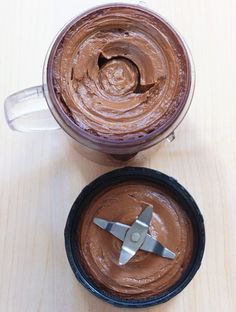 two bowls with chocolate frosting in them on a table