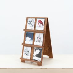 a wooden easel with four pictures on it