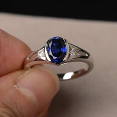 This is a gorgeous handmade creation. Its beauty is its simplicity & Elegance. The 6*8mm oval shape faceted lab sapphire is crafted in solid sterling silver and with rhodium plated. All item is sent in a beautiful gift box If you have any idea of design your ring,pls contact me directly. You can realize more lovely stuff clicking the link https://www.etsy.com/shop/knightjewelry?refshopsection_shophome_leftnav Please leave the correct address and you phone number for delivering successfully. September Birthstone Rings, Blue Gemstone Rings, Sapphire Solitaire, Blue Sapphire Ring, September Birthstone, Stone Engagement, Blue Sapphire Rings, Natural Blue Sapphire, Blue Gemstones