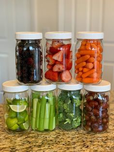 six jars filled with different types of fruits and veggies on a counter top