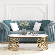 a living room with blue velvet couches and gold accents on the coffee table in front of it