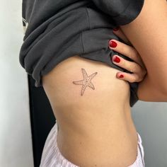 a woman with a starfish tattoo on her stomach