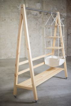 a wooden shelf with a toilet on it and some sort of ladder next to it