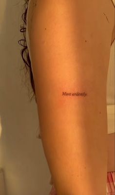 a woman's arm with the word most beautiful written in cursive font