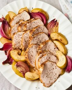 meat and vegetables on a plate with seasoning sprinkled on the top, ready to be eaten