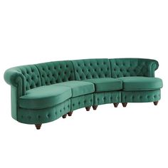 a green couch sitting on top of a white floor