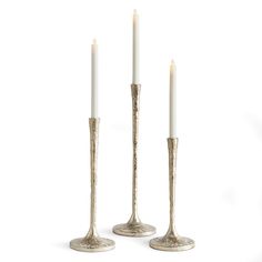 three candles are standing next to each other