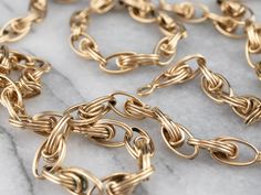 This vintage chain necklace has a beautiful intricacy! Crafted of 14 karat gold, this necklace has a rosy warmth to it that isn't found in modern chains. The woven links create a wonderful play of light and make this piece extra special!Metal: 14K Yellow GoldWidth of Chain: 6.0 mmLength of Chain: 24 InchesMarks: “14K” Stamped on the clasp Luxury Handmade Gold-plated Chain Necklace, Antique Style Oval Link Chain Necklace, Luxury Yellow Gold Chain Necklace With Hook And Links, Yellow Gold Necklaces With Hook And Links For Gift, Vintage Cable Chain Necklace For Formal Occasions, Yellow Gold Link Necklace, Round Yellow Gold Jewelry With Hooks And Links, Vintage Formal Cable Chain Necklace, Heirloom Link Necklace For Formal Occasions