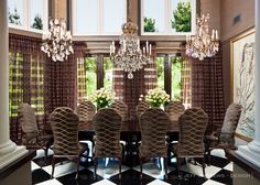 a dining room table and chairs with chandelier