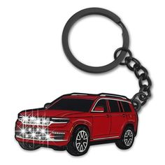 a red car keychain that is shaped like a jeep with lights on it