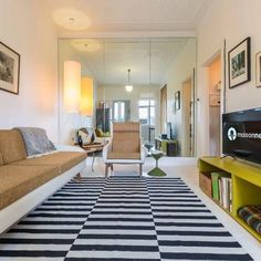 a living room filled with furniture and a flat screen tv