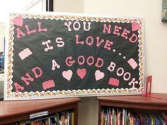 a blackboard with pink writing on it that says all you need is love and a good book