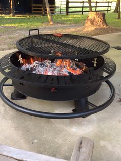 an outdoor fire pit sitting on top of a cement slab