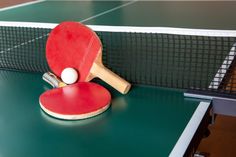 two ping pong paddles on top of a table