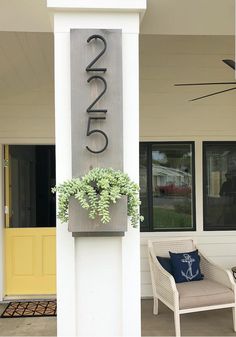 the front porch of a house with a chair and planter on it's side