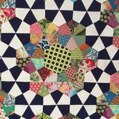 an image of a patchwork quilt with many different colors and patterns on it's surface