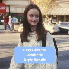 a girl with long brown hair is standing on the street