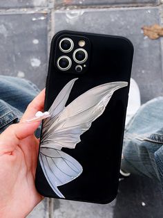 a person holding up a phone case with an image of a white butterfly on it