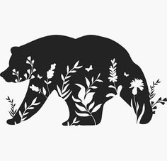 a black and white silhouette of a bear surrounded by flowers