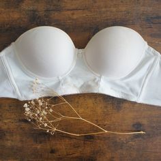 Beautiful Longline Bra By Freya In The Ivory Colorway. Can Be Worn Strapless Or With Straps, The Straps Can Be Arranged In Multiple Ways As There Are 8 (Or 4 Pairs) Of Hooks For The Two Straps. Features A Delicate Floral Pattern Panel At The Center Along With Two Decorative Buttons. Never Worn, But Without Tags. Straps Are Included, I Just Forgot To Put Them In The Pictures! Feel Free To Request Additional Photos :) Cream Push-up Bra With Built-in Support, White Underwire Bra With Removable Cups, Elegant White Bra With Removable Cups, Elegant White Stretch Bra, Elegant White Bra With Lined Body, White Bandeau Intimate With Medium Bust Support, Elegant White Strapless Bra, Elegant White Underbust Bra, Elegant White Lined Bra