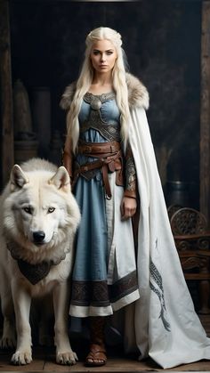 a woman in a blue dress standing next to a white wolf