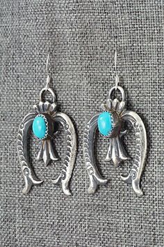 These turquoise and sterling silver earrings were made by Navajo silversmiths Eva & Linberg Billah. The backs are signed EL and stamped sterling.Length: 1 7/8"Width: 1 1/8"Free shipping on all orders! We ship with USPS and always include tracking. All orders ship within a day of payment.Returns are accepted up to 30 days after you receive your order. Just send us a message. Our shop offers cash back or store credit. The item must be returned in new condition. Nickel Free Sterling Silver Western Earrings, Handmade Western Turquoise Earrings, Turquoise Dangle Earrings Western Style, Western Turquoise Dangle Earrings, Nickel-free Adjustable Southwestern Earrings, Turquoise Sterling Silver Nickel-free Hoop Earrings, Western Style Turquoise Nickel-free Earrings, Western Turquoise Nickel-free Earrings, Turquoise Nickel-free Southwestern Teardrop Earrings