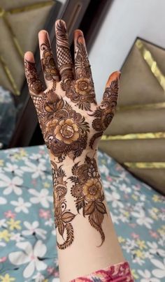 a woman's hand with hennap on it and flowers around the wrist