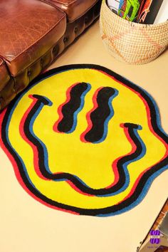 a yellow rug with black and red lines on it next to a brown leather chair