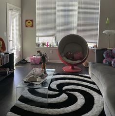 a living room filled with furniture and a large rug on top of a hard wood floor