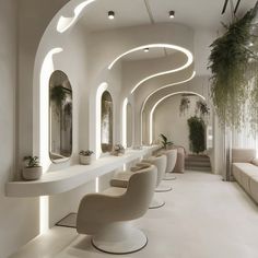 the interior of a hair salon with white walls and curved mirrors on either side of the room