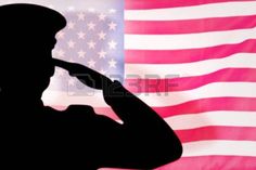 the silhouette of a soldier saluting in front of an american flag