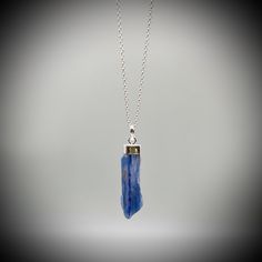 Blue Kyanite Crystal Point  and Sterling Silver Pendant on your choice of with a  16 or 18 inch sterling silver belcher chain. This is a beautiful Kyanite crystal blade, approximately 3.5cm x 1cm Our jewellery always comes beautifully gift boxed and bagged with a crystal meaning card.  BLUE KYANITE BENEFITS Aids with healing of the throat Strengthens the voice and gives confidence Creates Soothing and harmonic energy Encourages self-expression and communication All of our crystal are ethically sourced and are treated with love, care and respect. Blue Tanzanite Jewelry As A Gift, Blue Tanzanite Jewelry Perfect As A Gift, Handmade Tanzanite Blue Jewelry, Blue Tanzanite Pendant Jewelry, Sodalite Pendant Jewelry Gift, Blue Sodalite Pendant Necklace, Blue Spiritual Crystal Birthstone Necklace, Sapphire Pendant Crystal Necklace For Gift, Sapphire Pendant Crystal Necklace As Gift