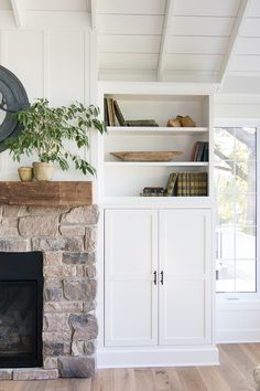 a living room with a fire place and bookshelves