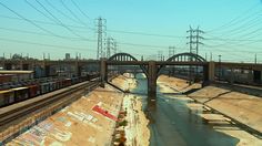 a train traveling over a bridge next to a river