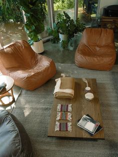 a living room with two leather chairs and a coffee table