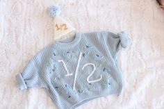 Beautiful hand embroidered birthday chunky sweater. Perfect for your baby's birthday celebration.  This listing is for one sweater only. If you want a different color, just send us a convo Hand embroidery on a chunky sweater True to size Custom orders welcome Embroidered Winter Birthday Sweater, Month Embroidery, Embroidery Name Sweater, Embroidered Sweater Kids, Embrodered Newborn Crewneck Sweater, Hand Embroidered Sweater, Embroidered Baby Name Sweater, Embroidered Sweaters, Birthday Sweater