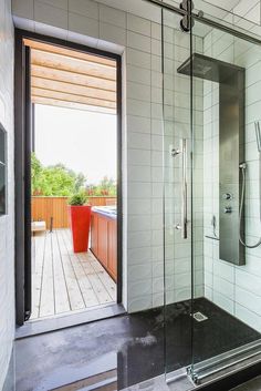 a bathroom with a walk in shower next to a wooden deck