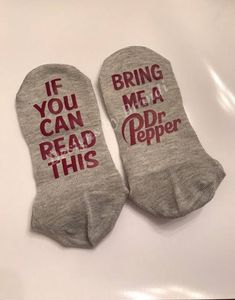 two socks that say, if you can read this bring me a soda popper