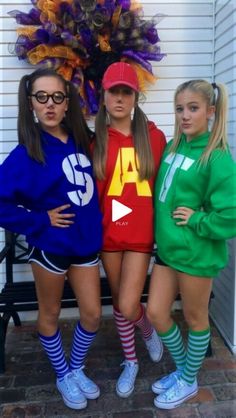 three girls in matching outfits posing for the camera