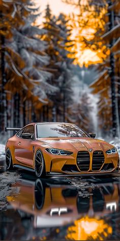 an orange sports car parked in front of some trees