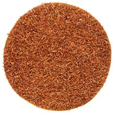 a round rug made out of various types of wood shavings on a white background