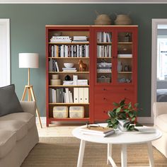 a living room filled with furniture and a book shelf