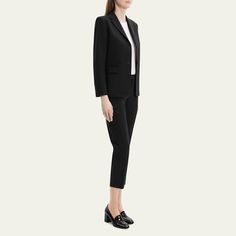 Theory clean blazer with a three-button cuff finish Notched lapels; two-button front Long sleeves Front flap pockets Cutaway hem Tailored fit Wool/elastane Dry clean Imported Classic Pantsuit With Suit Collar For Office, Business Casual Long Sleeve Pantsuit With Pressed Crease, Sleek Suits With Hidden Button Closure For Work, Flat Front Suits With Button Cuffs For Work, Professional Blazer With Pressed Crease For Office, Sleek Single Breasted Pantsuit For Workwear, Classic Notch Lapel Pantsuit For Office, Single Button Long Sleeve Pantsuit For Work, Office Blazer With Concealed Placket And Notched Lapels